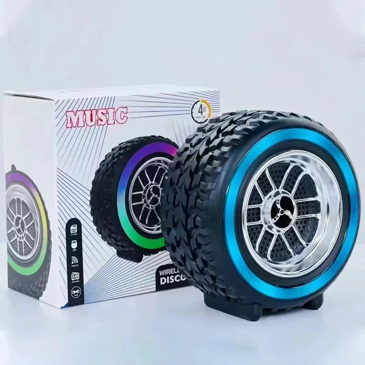 Black and blue wheel-shaped speaker with colorful rim design in front of a box labeled 'Music'.