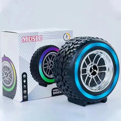 Black and blue wheel-shaped speaker with colorful rim design in front of a box labeled 'Music'.