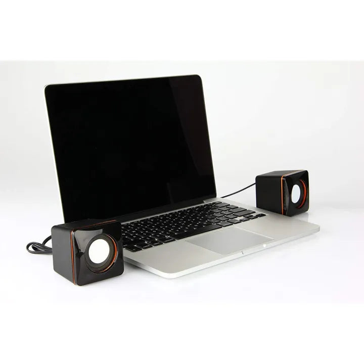 Laptop with two external speakers on a white background