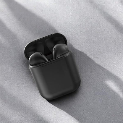 Black wireless earbuds in a charging case on a gray fabric background