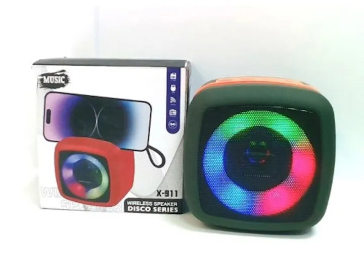 Colorful wireless speaker with LED lights next to its packaging on a white background