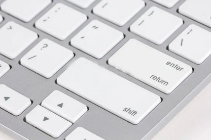 Close-up of a computer keyboard with focus on the enter key