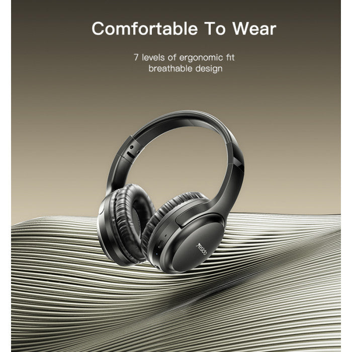 Black headphones on a textured surface with text about comfort and design.