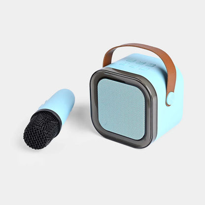 Blue cylindrical speaker with a black mesh grille on a light gray background