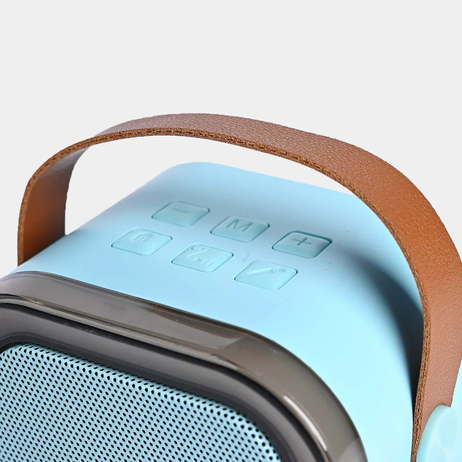 Close-up of a portable speaker with a brown handle and blue body on a light gray background