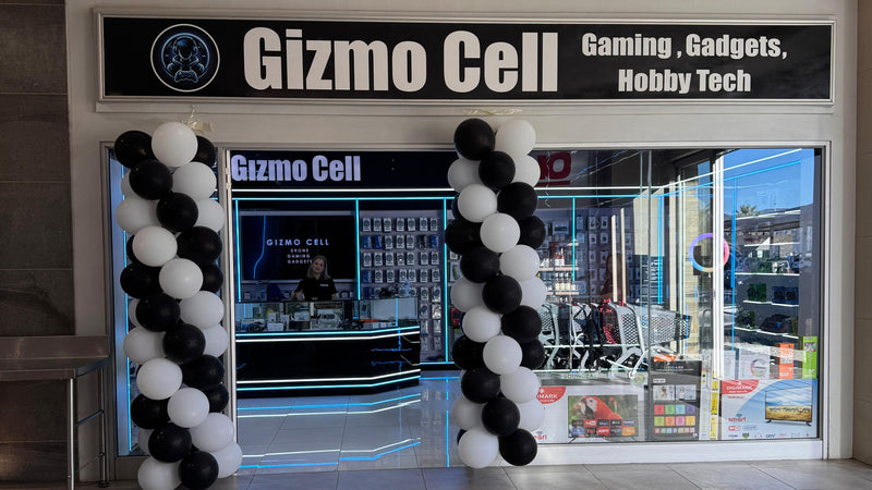 Store entrance with 'Gizmo Cell' sign and decorative balloons.