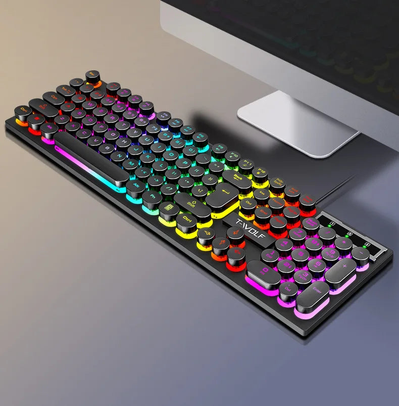 Mechanical keyboard with RGB lighting on a desk next to a computer monitor.