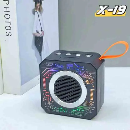 Black portable speaker with colorful circuit design on a white surface, featuring the brand 'X-19'.