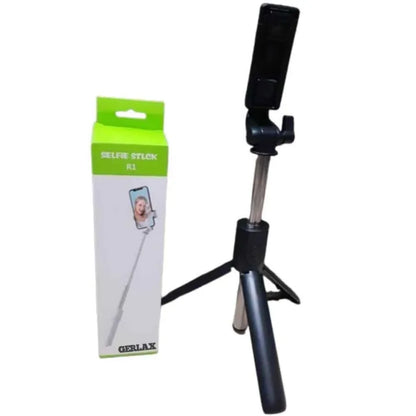 Black selfie stick with adjustable tripod and packaging on a white background