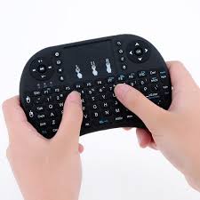 Handheld keyboard with touchpad held by two hands on a white background