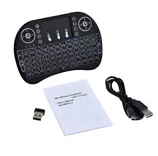 Black wireless keyboard with remote control, USB receiver, and user manual on a white background