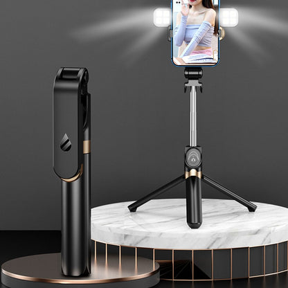 Black smartphone holder with remote control on a marble platform against a dark background