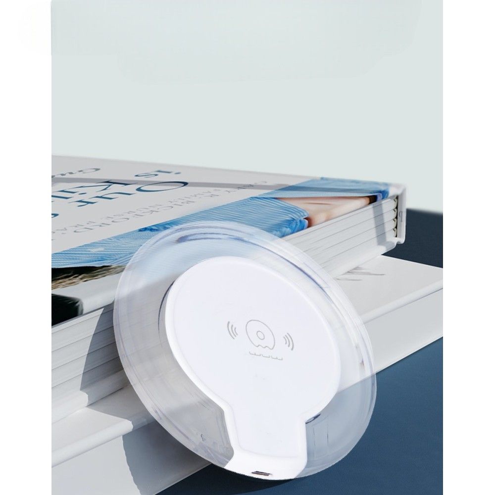 White electronic device with a clear cover on top of a magazine